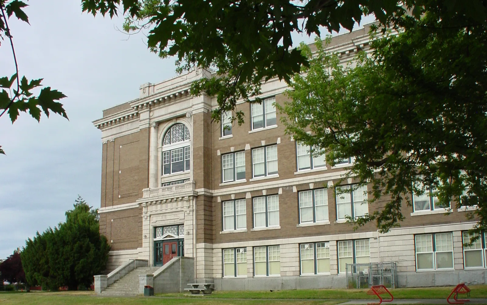 The Victoria High School facade in summer — the modillion cornice, pier and windowsill courses Szolyd’s restoration programme worked on