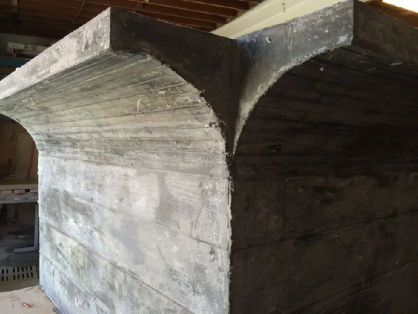 The demolded panel showing the board-formed timber grain picked up in the UHPC face