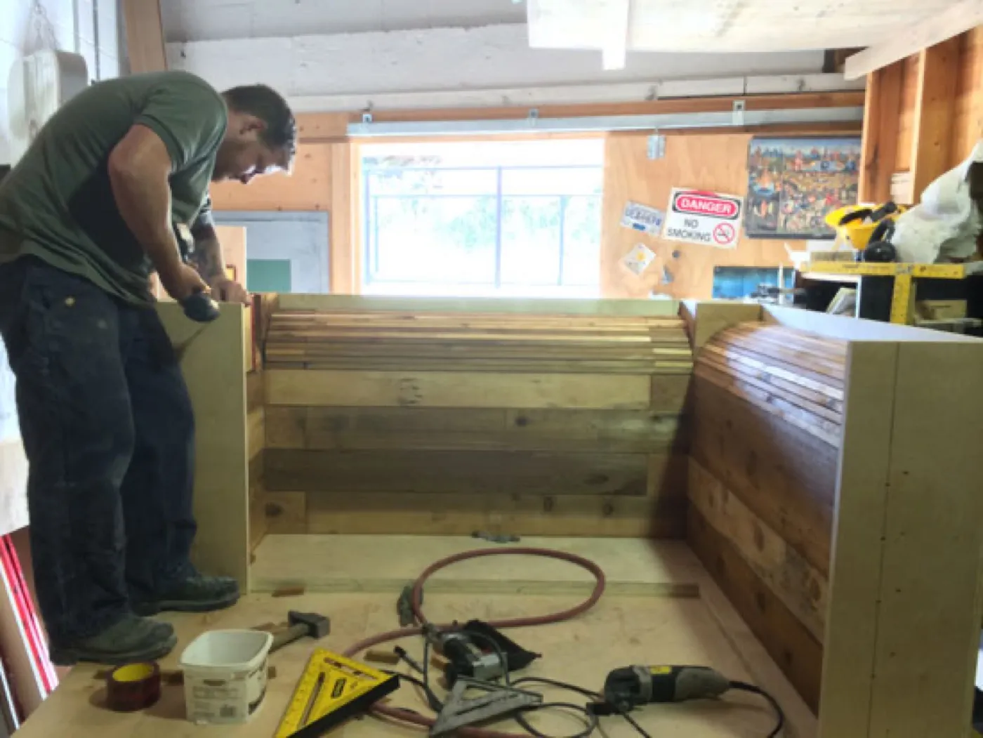 The board-formed mold built in the shop, timber laid up to give the UHPC its grain