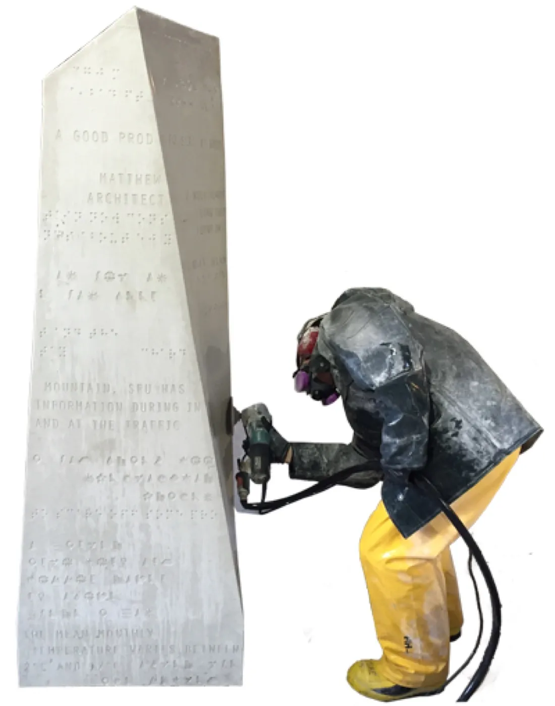A worker in full protective gear grinding and polishing the lettered face of a finished module