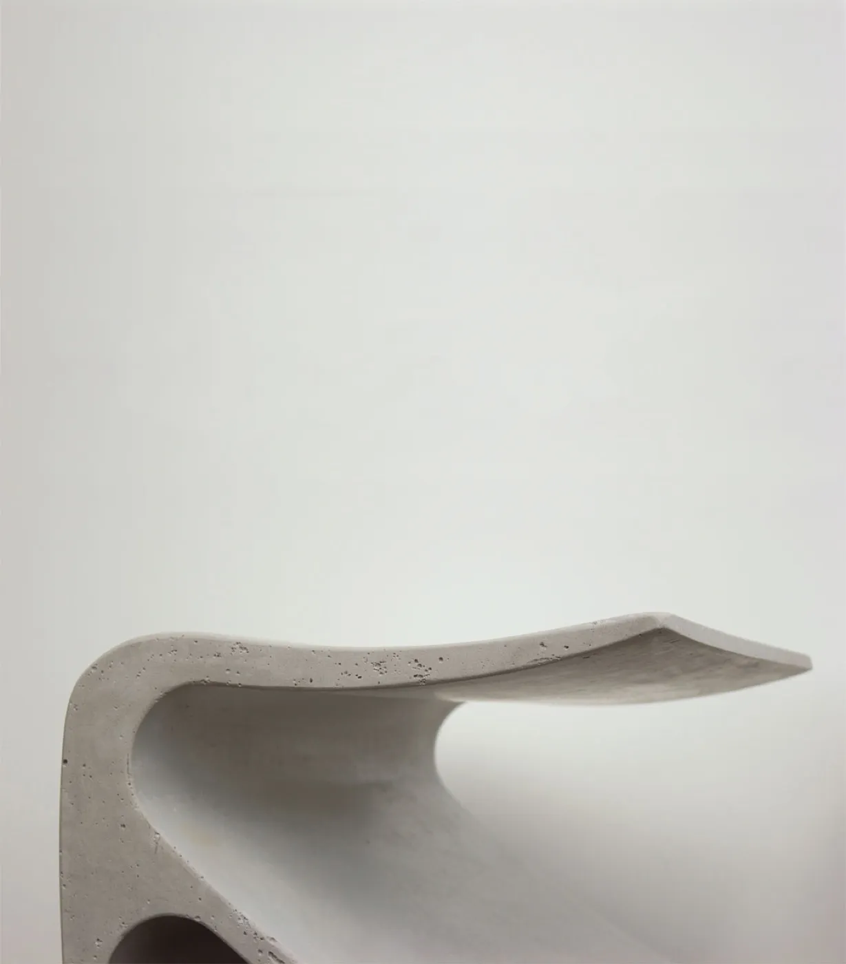 The finished white Sofi bench, one continuous surface sweeping from seat to leg