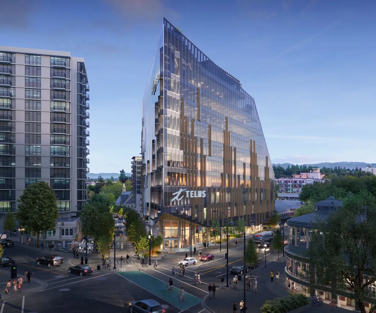 Rendering of the completed Telus Ocean building at dusk — the glass flatiron prow rising above the Douglas Street corner, lit from within